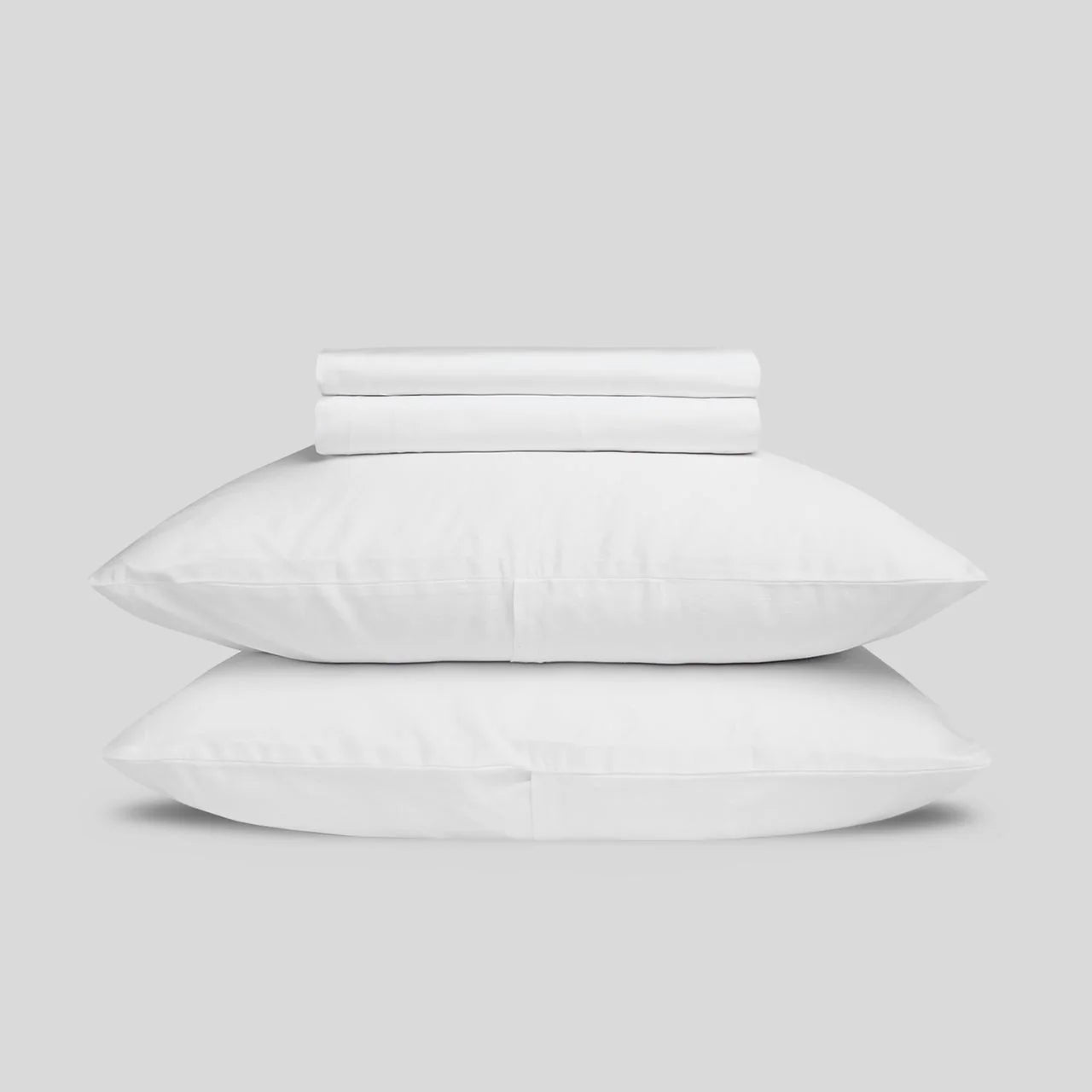 Stack of white bedding on a light gray background